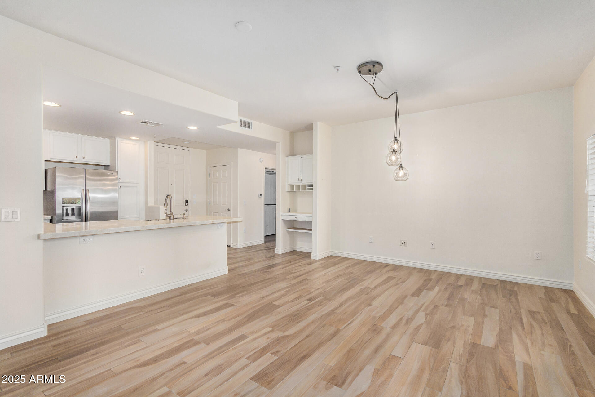 5450 East Deer Valley Drive, Unit 1211 Phoenix, AZ 85054 - Photo 25 of 26 a view of kitchen with wooden floor and window