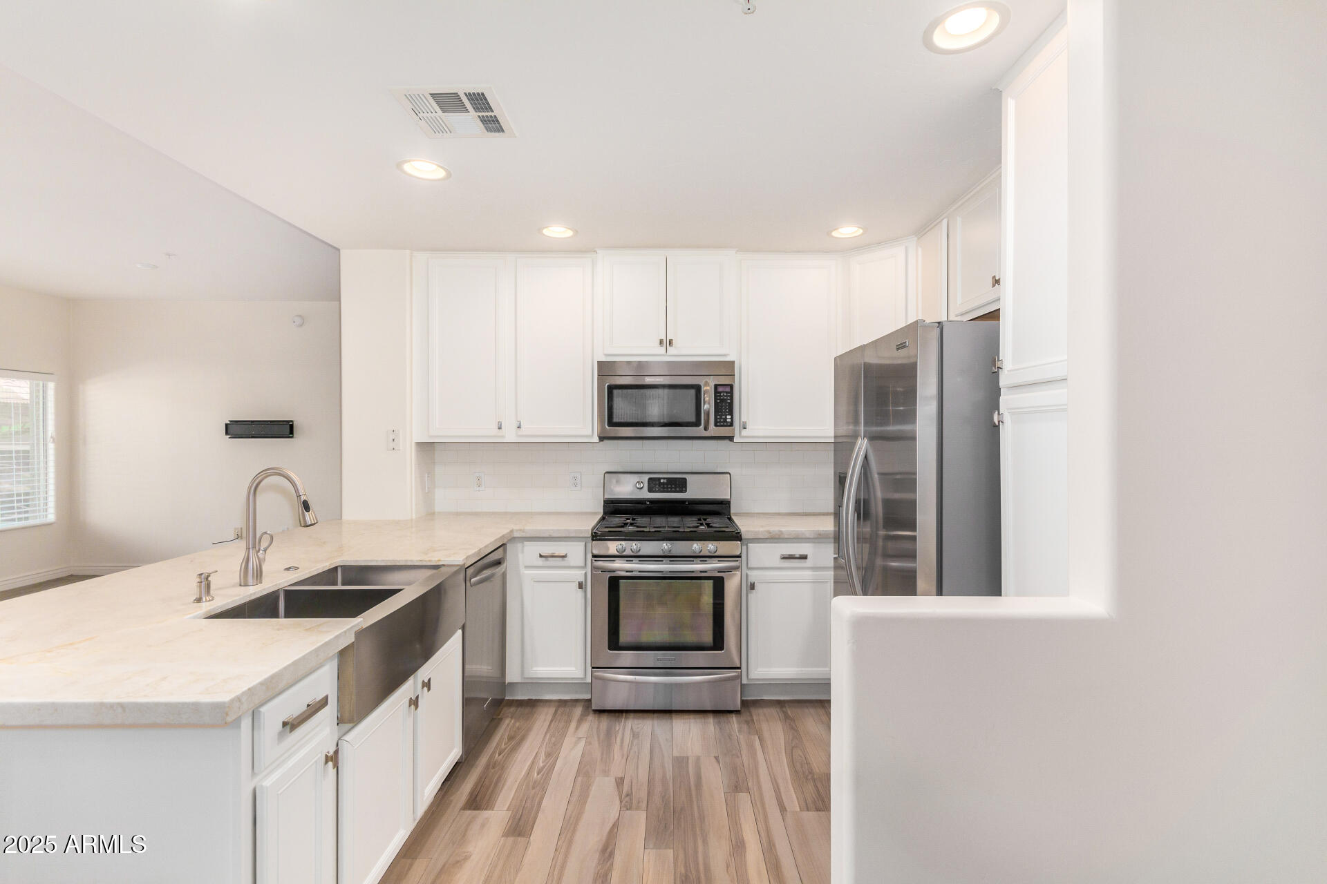 5450 East Deer Valley Drive, Unit 1211 Phoenix, AZ 85054 - Photo 3 of 26 a kitchen with a sink stove and refrigerator