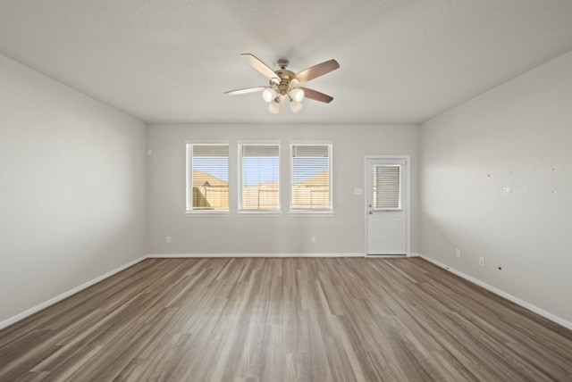 10422 Sherwin Pass Drive Rosharon, TX 77583 - Photo 13 of 26 wooden floor in an empty room with a window