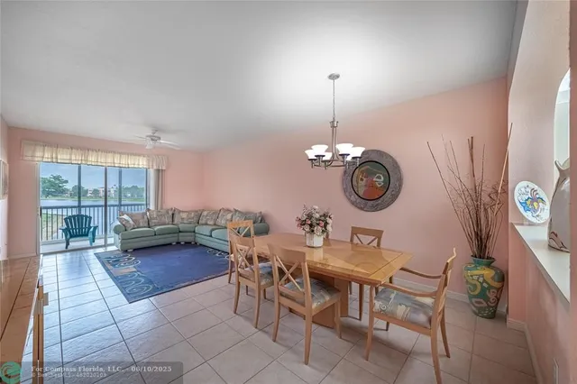 a view of a workspace with furniture and a large window