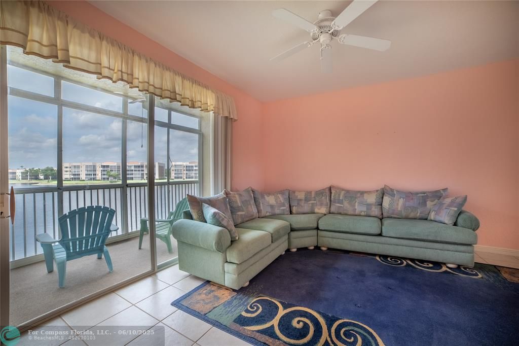 7739 Southampton Terrace, Unit 202 Tamarac, FL 33321 - Photo 15 of 39 a living room with furniture and a floor to ceiling window