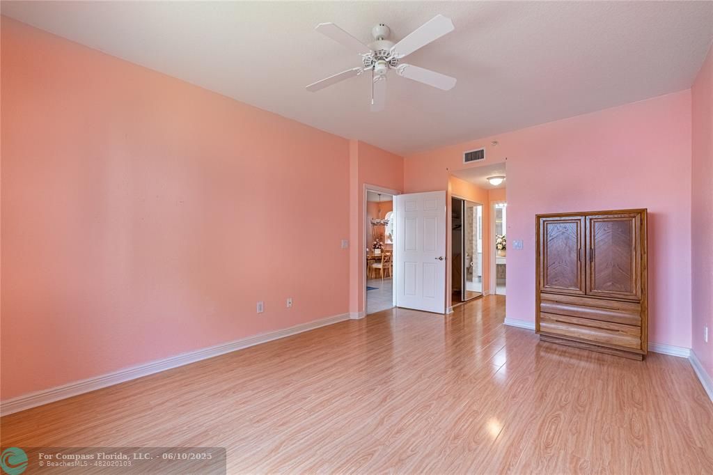 7739 Southampton Terrace, Unit 202 Tamarac, FL 33321 - Photo 18 of 39 a view of an empty room with wooden floor and a ceiling fan