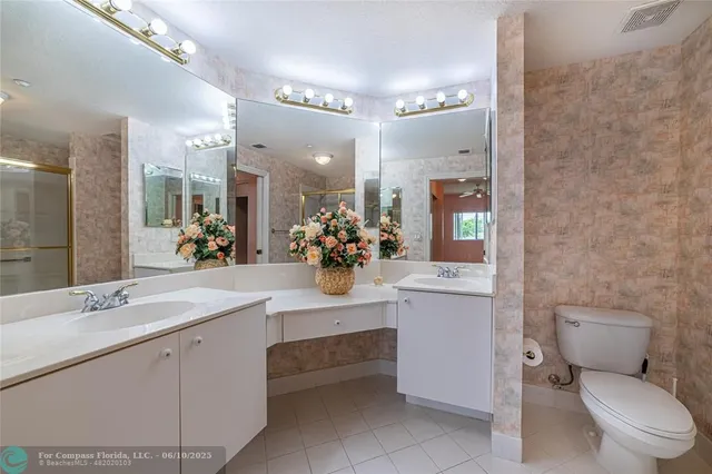 a bathroom with a sink a toilet and mirror