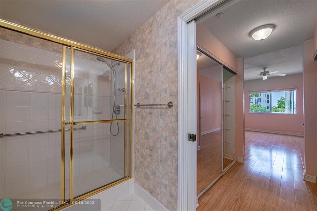 7739 Southampton Terrace, Unit 202 Tamarac, FL 33321 - Photo 20 of 39 a bathroom with a glass shower door