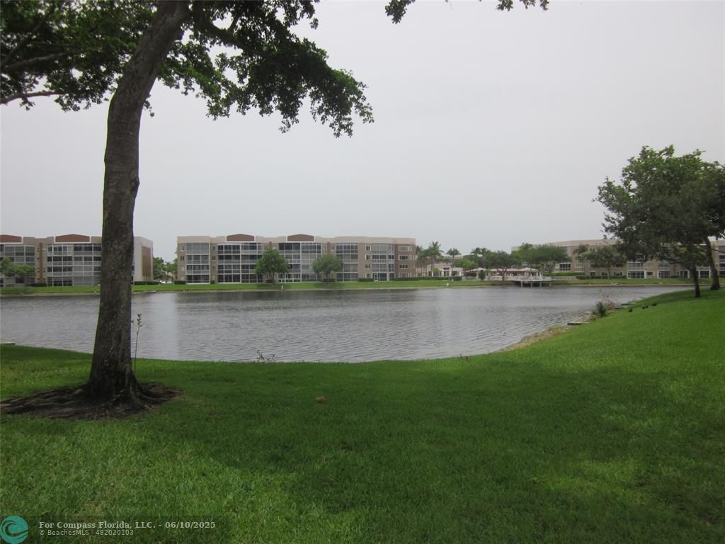 7739 Southampton Terrace, Unit 202 Tamarac, FL 33321 - Photo 2 of 39 a view of a lake with a big yard