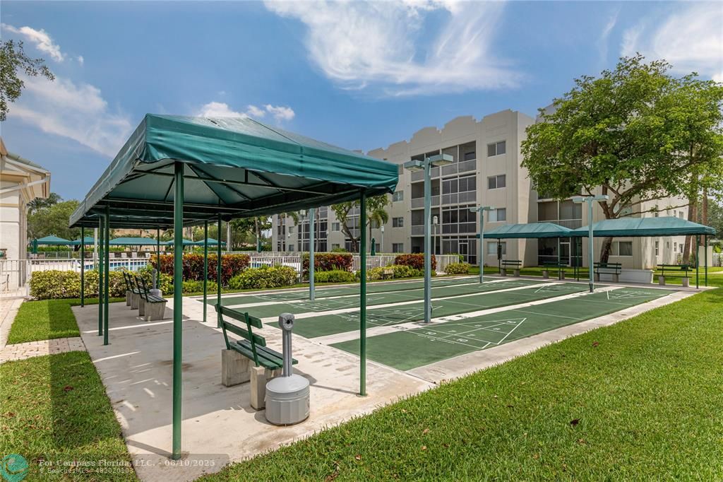 7739 Southampton Terrace, Unit 202 Tamarac, FL 33321 - Photo 27 of 39 a view of a patio with a table chairs and a backyard