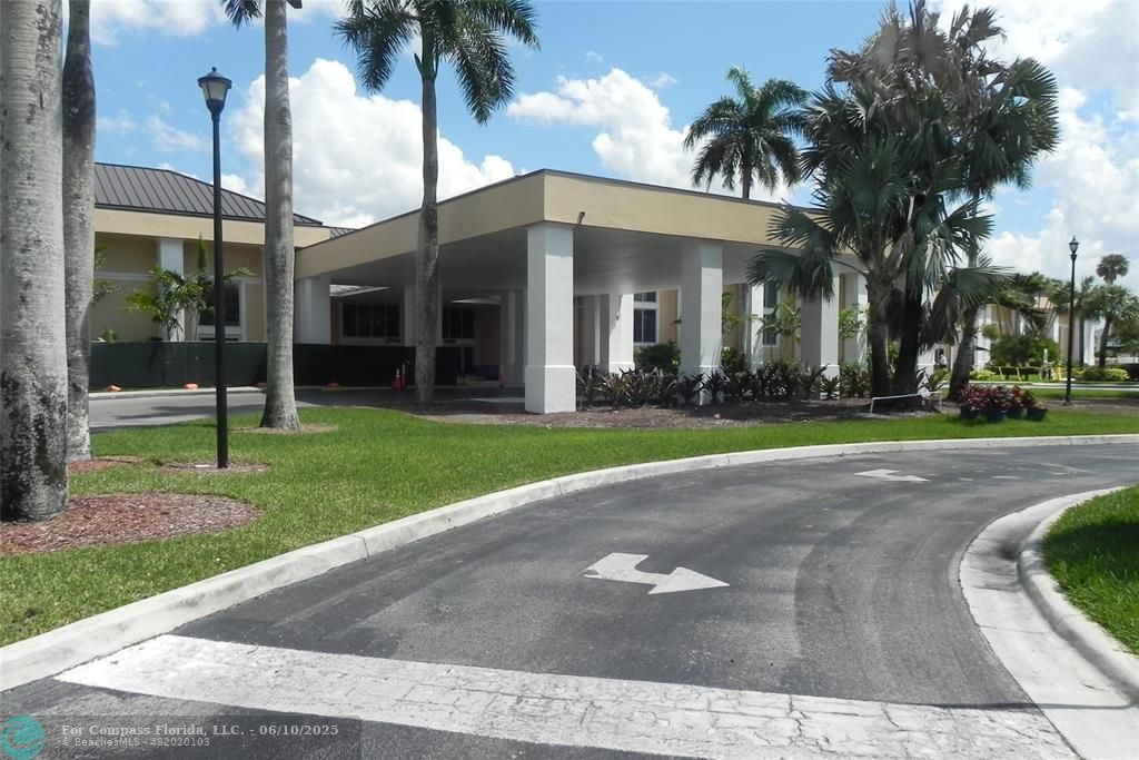 7739 Southampton Terrace, Unit 202 Tamarac, FL 33321 - Photo 28 of 39 a view of a house with a yard and palm trees