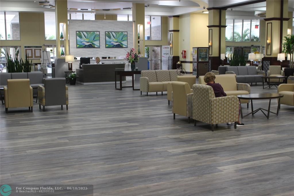 7739 Southampton Terrace, Unit 202 Tamarac, FL 33321 - Photo 30 of 39 a living room with furniture wooden floor and a chandelier