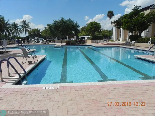 a view of a swimming pool with lounge chair