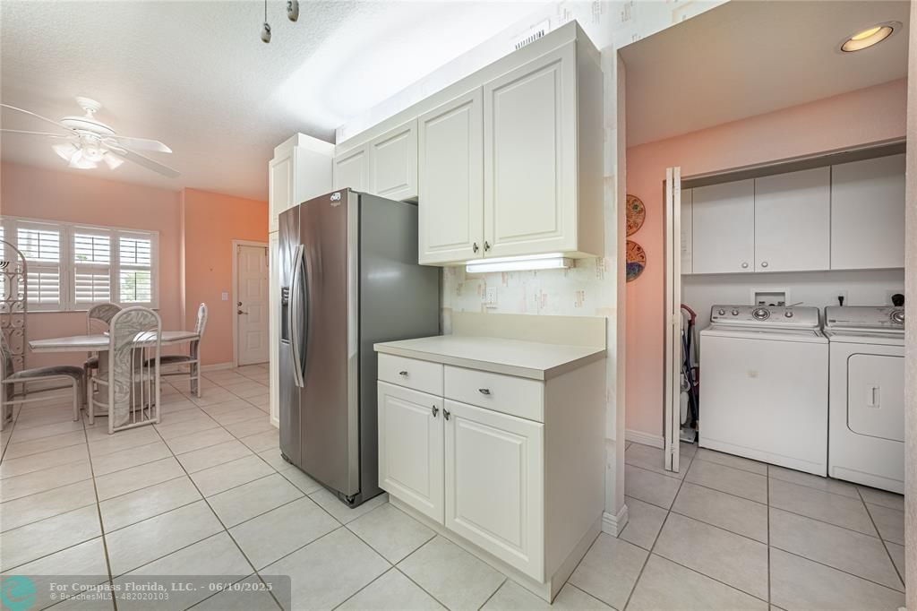 7739 Southampton Terrace, Unit 202 Tamarac, FL 33321 - Photo 7 of 39 a kitchen with white cabinets and appliances