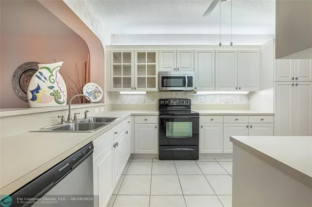 a kitchen with a sink stove and cabinets