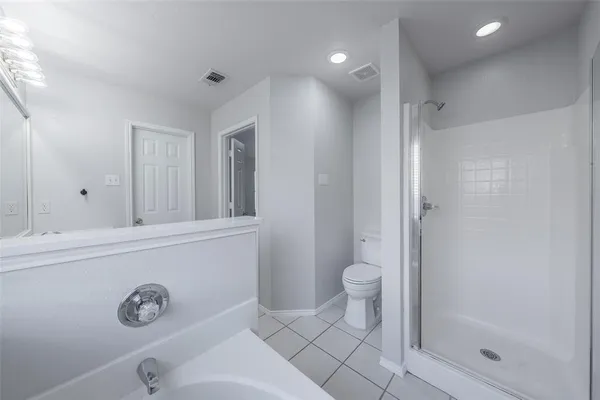 a bathroom with a granite countertop sink a toilet and a shower