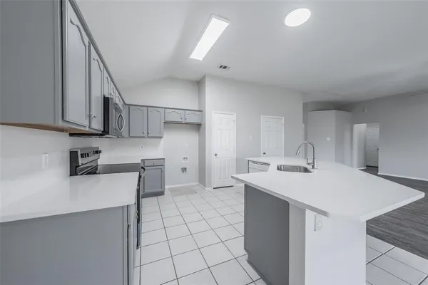 a kitchen with a sink appliances and cabinets