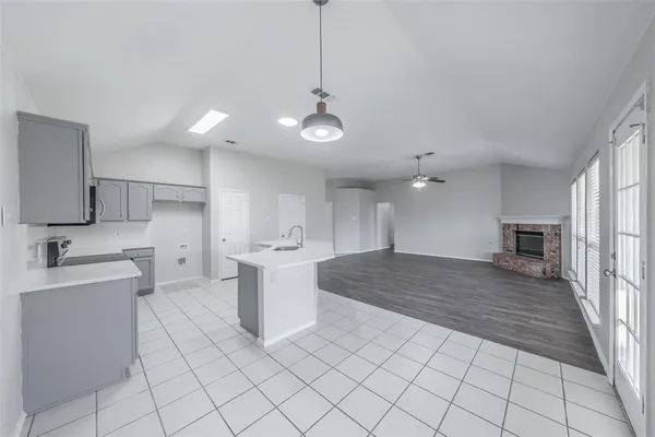 a kitchen with a sink appliances and cabinets