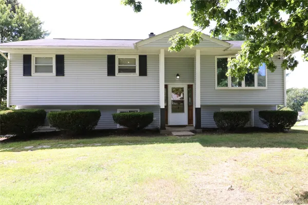 a view of a house with a yard and a garage