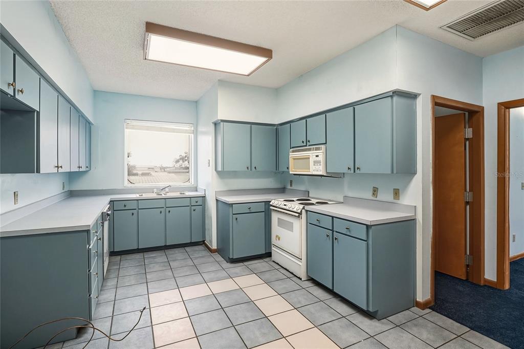1803 3rd Street Southwest Winter Haven, FL 33880 - Photo 19 of 66 a kitchen with a sink cabinets and window