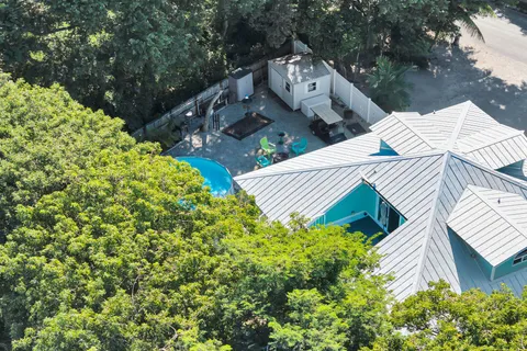 a view of house with backyard outdoor seating and green space