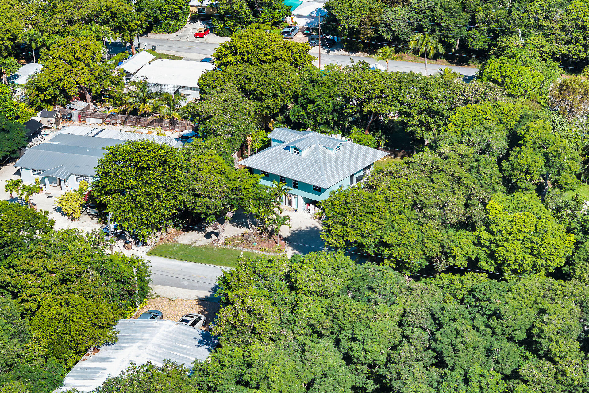 593 Bonito Avenue Key Largo, FL 33037 - Photo 67 of 72 an aerial view of a house with a yard and large trees
