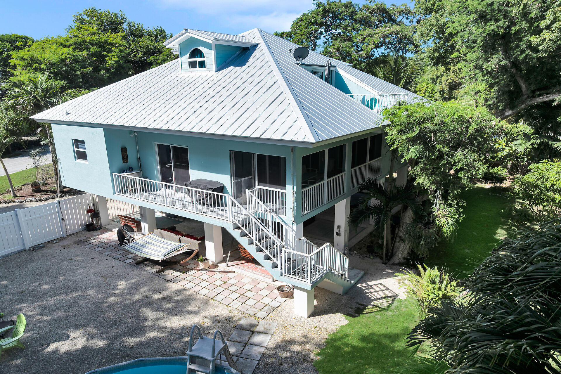 593 Bonito Avenue Key Largo, FL 33037 - Photo 8 of 72 a view of house with backyard outdoor seating and green space