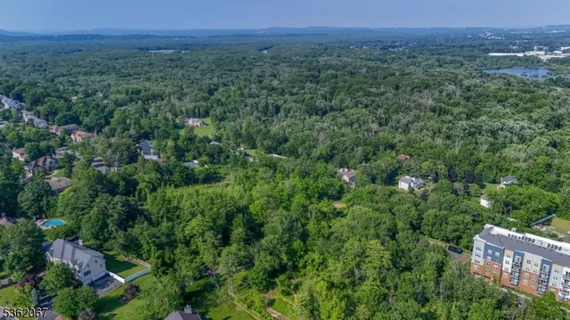 an aerial view of residential house with outdoor space and swimming pool