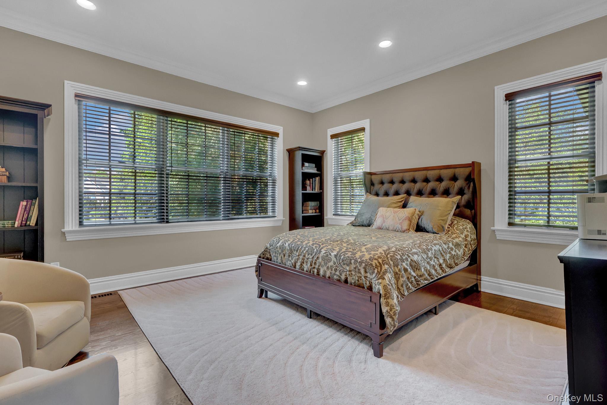 36 Old Field Road Setauket, NY 11733 - Photo 39 of 42 a spacious bedroom with a large bed and a large window
