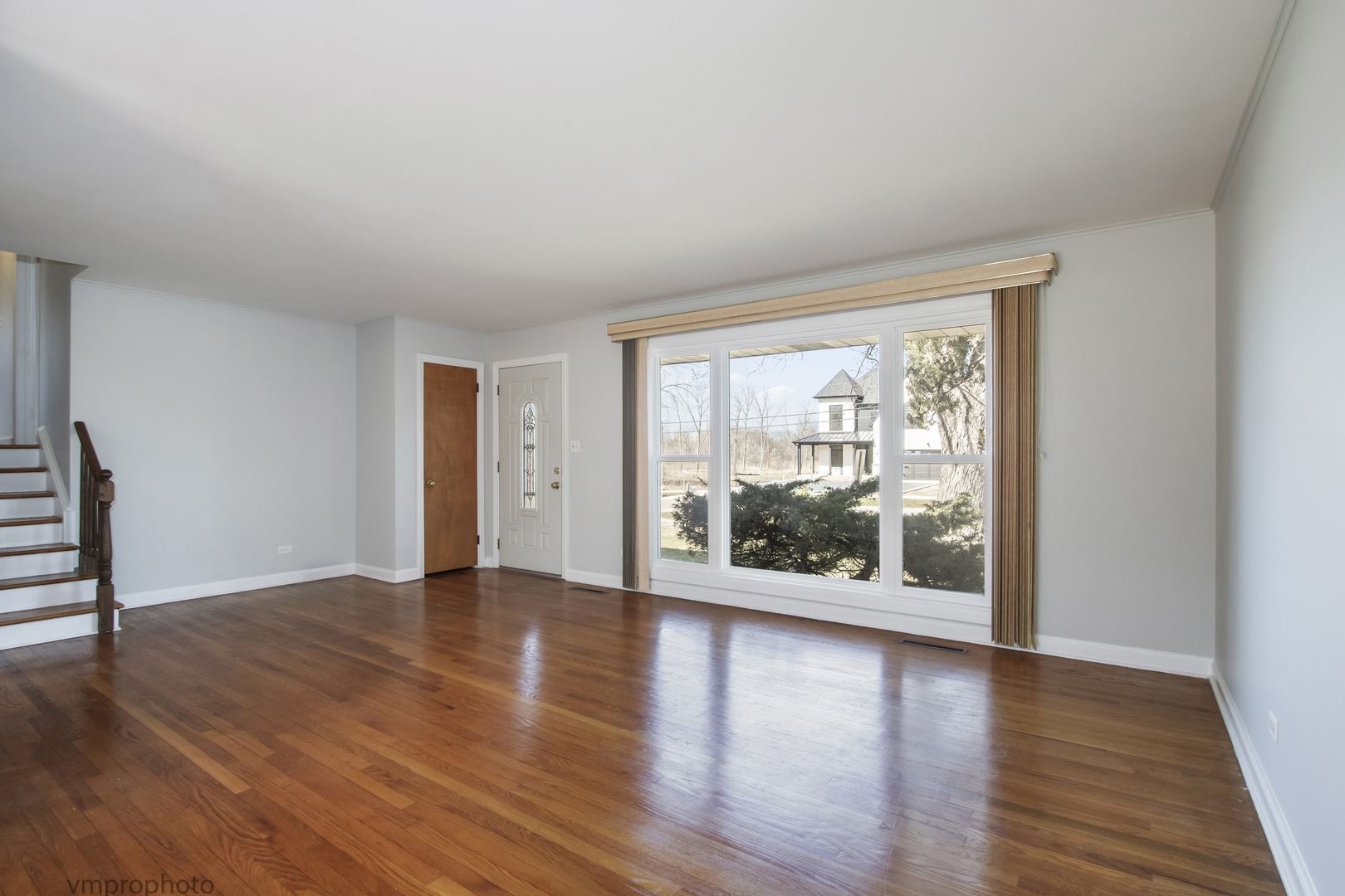 61 Miller Road Lake Zurich, IL 60047 - Photo 3 of 31 wooden floor in an empty room with a window