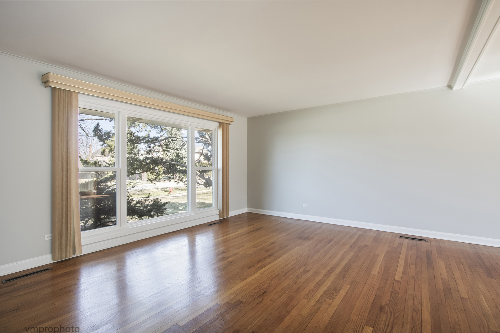 61 Miller Road Lake Zurich, IL 60047 - Photo 6 of 31 a view of an empty room with wooden floor and a window