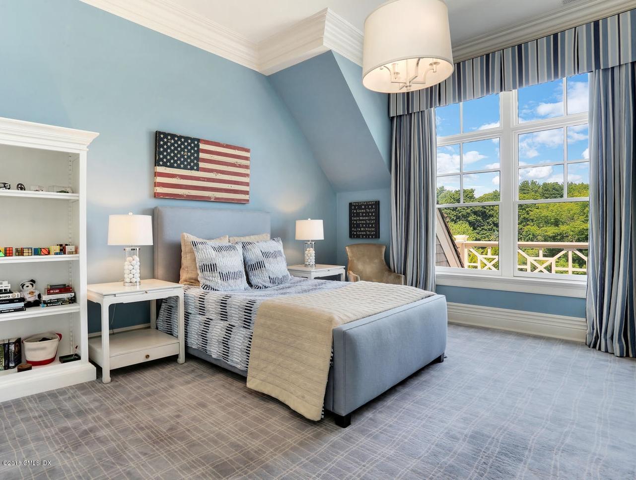 35 Close Road Greenwich, CT 06831 - Photo 44 of 78 a spacious bedroom with a bed and a chandelier