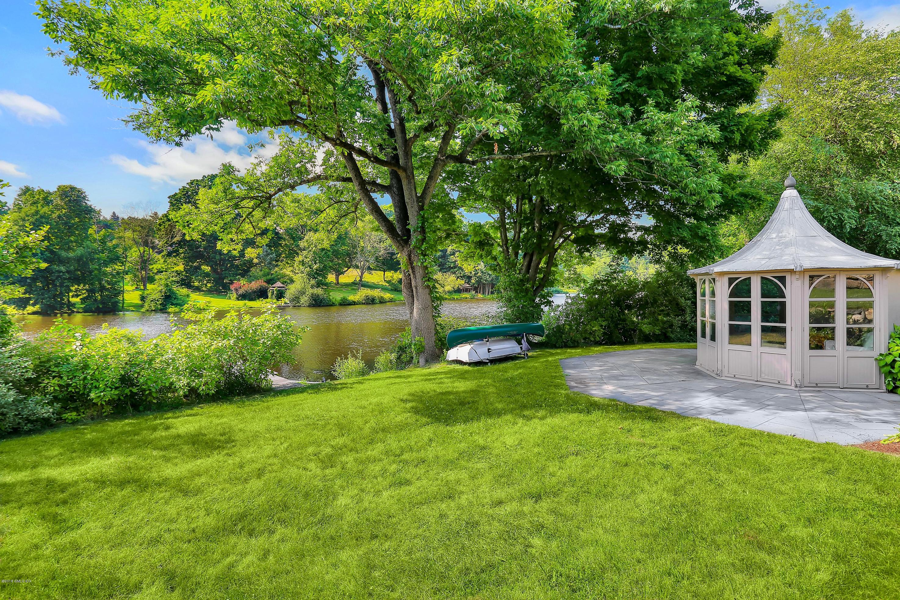 35 Close Road Greenwich, CT 06831 - Photo 64 of 78 a view of a house with a yard and a large tree