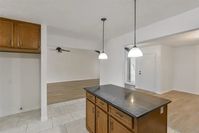 a kitchen with a table a sink and cabinets