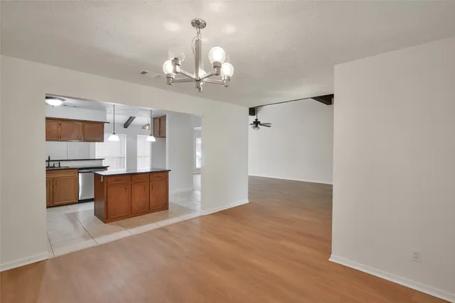 a view of a kitchen with a sink and a refrigerator