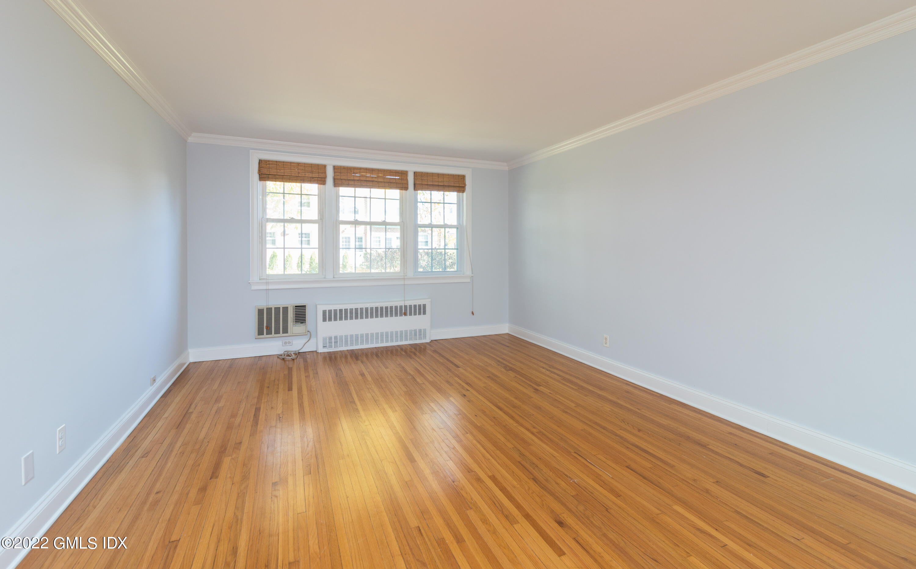 70 Putnam Park, Unit 70 Greenwich, CT 06830 - Photo 11 of 20 an empty room with wooden floor and windows