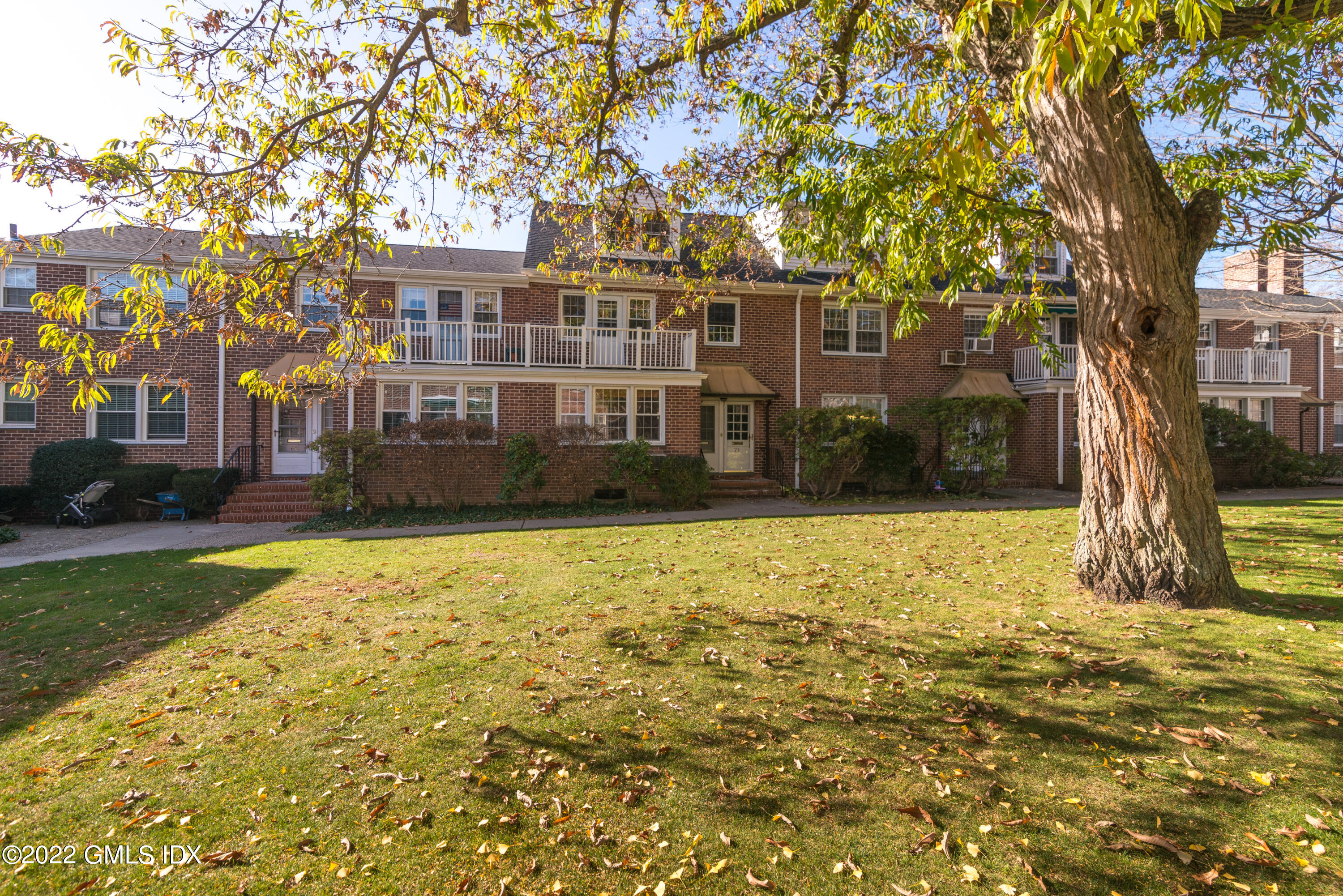 70 Putnam Park, Unit 70 Greenwich, CT 06830 - Photo 20 of 20 a front view of a house with a yard
