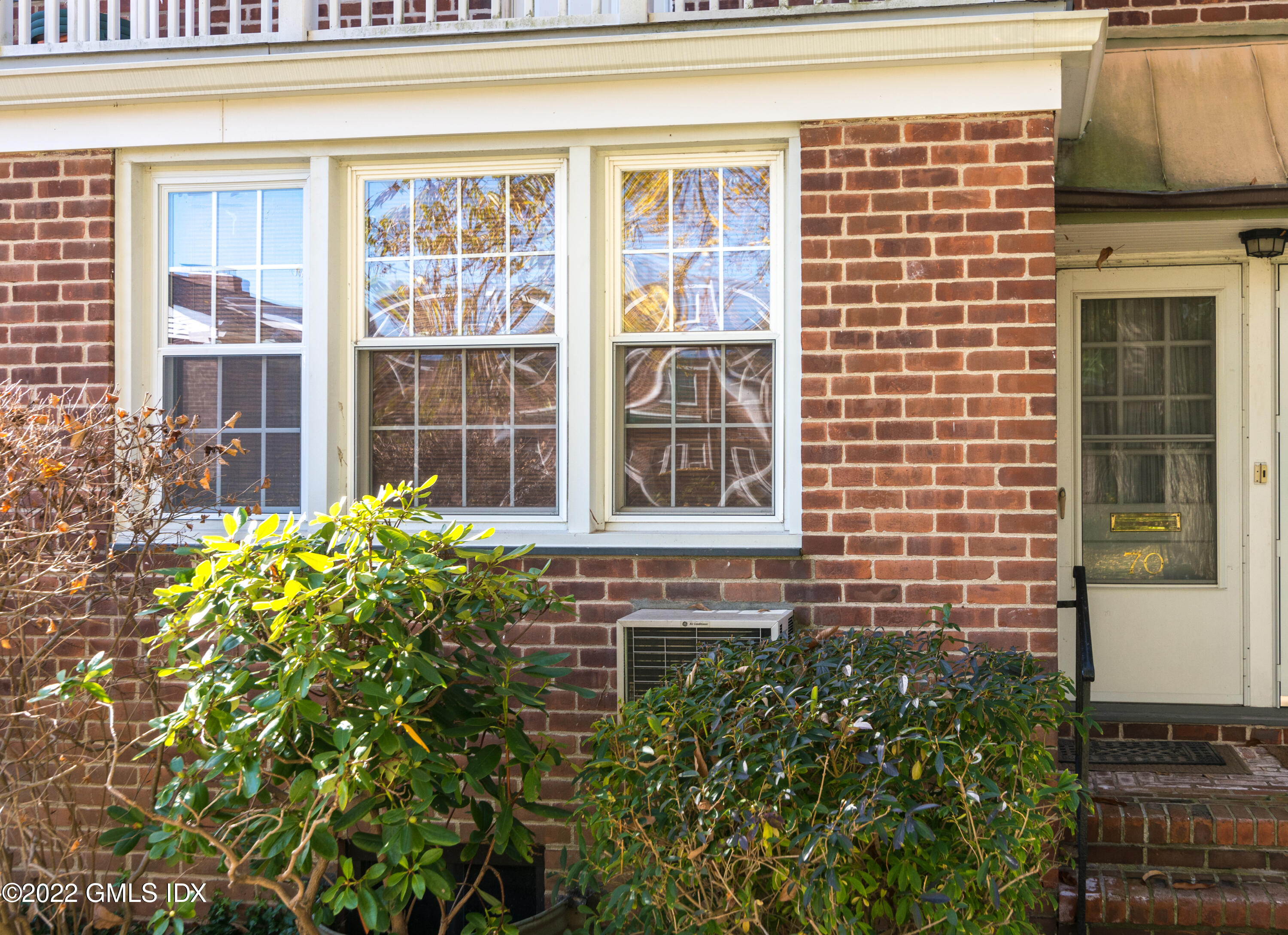 70 Putnam Park, Unit 70 Greenwich, CT 06830 - Photo 2 of 20 a view of a building with a garden