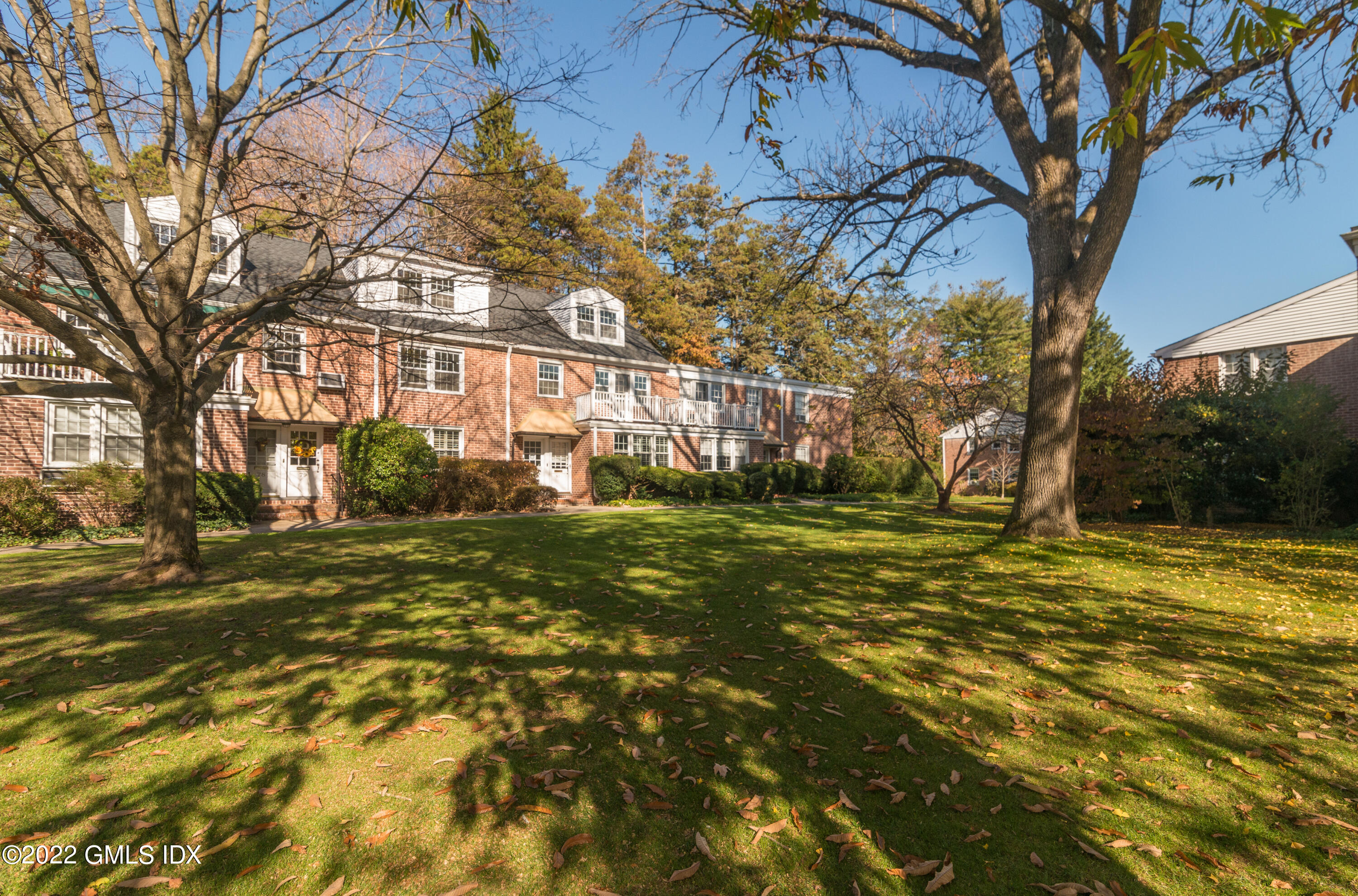 70 Putnam Park, Unit 70 Greenwich, CT 06830 - Photo 3 of 20 a view of a yard with a tree