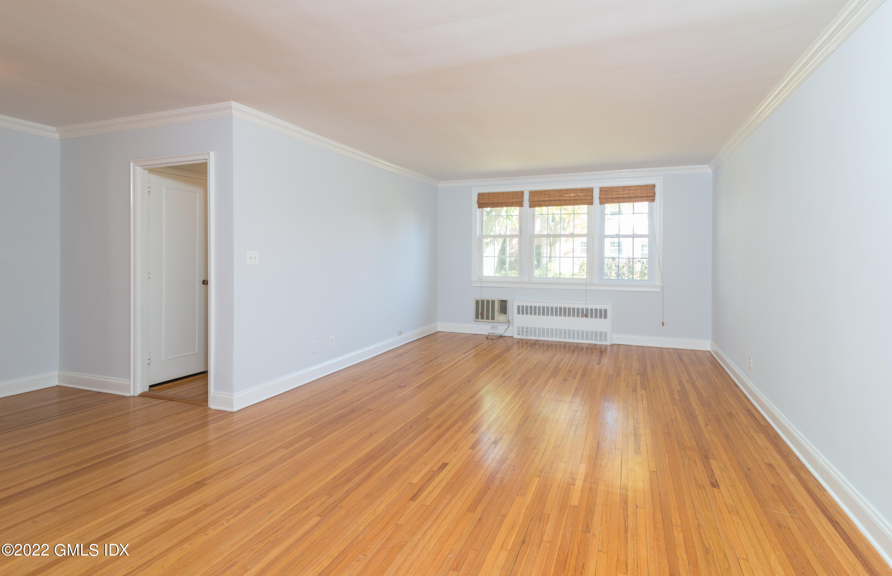 70 Putnam Park, Unit 70 Greenwich, CT 06830 - Photo 10 of 20 an empty room with wooden floor and windows