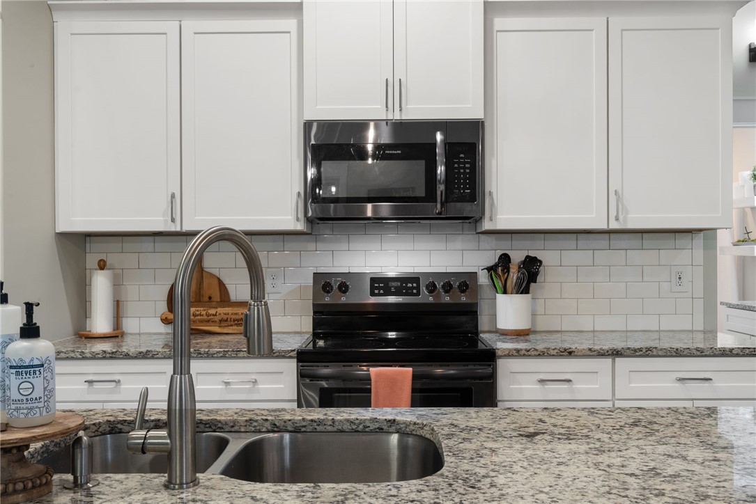 201 Hearthstone Drive Anderson, SC 29621 - Photo 21 of 49 Culinary delights await in this modern kitchen with pristine white cabinetry and elegant granite counters.