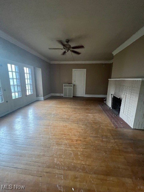 2915 Ludlow Road Cleveland, OH 44120 - Photo 30 of 50 Unfurnished living room with a fireplace, ornamental molding, hardwood / wood-style floors, and ceiling fan