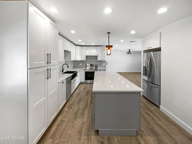 a bathroom with a granite countertop sink and shower