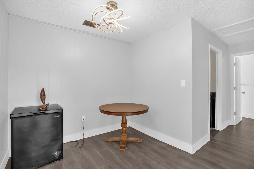 1121 Spring Meadow Drive, Unit 11221 Kissimmee, FL 34741 - Photo 13 of 28 a room with a table and a potted plant