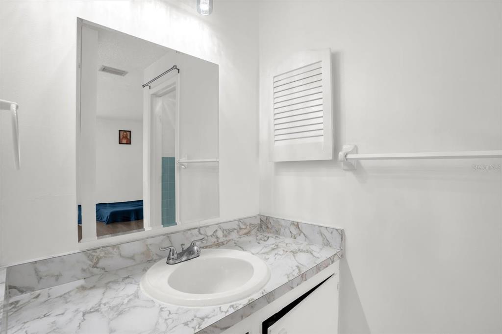 1121 Spring Meadow Drive, Unit 11221 Kissimmee, FL 34741 - Photo 16 of 28 a bathroom with a sink and a mirror