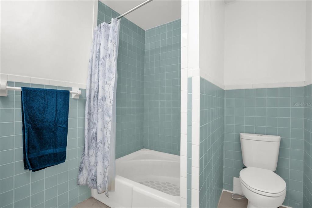 1121 Spring Meadow Drive, Unit 11221 Kissimmee, FL 34741 - Photo 17 of 28 a bathroom with a toilet and a shower