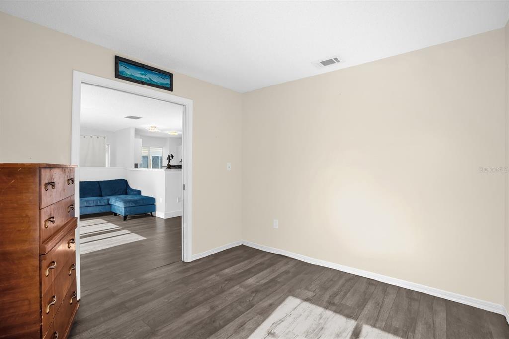1121 Spring Meadow Drive, Unit 11221 Kissimmee, FL 34741 - Photo 19 of 28 a view of a living room with wooden floor