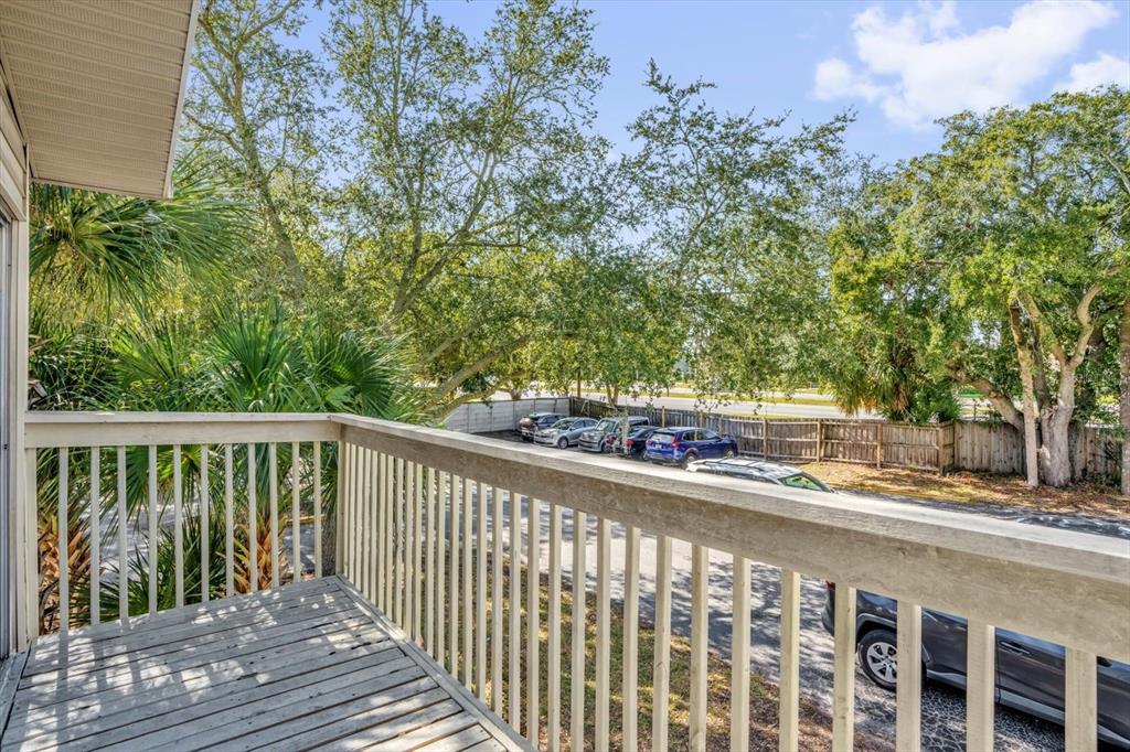 1121 Spring Meadow Drive, Unit 11221 Kissimmee, FL 34741 - Photo 21 of 28 a balcony with wooden floor and yard in the back