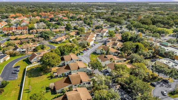 an aerial view of residential houses with outdoor space