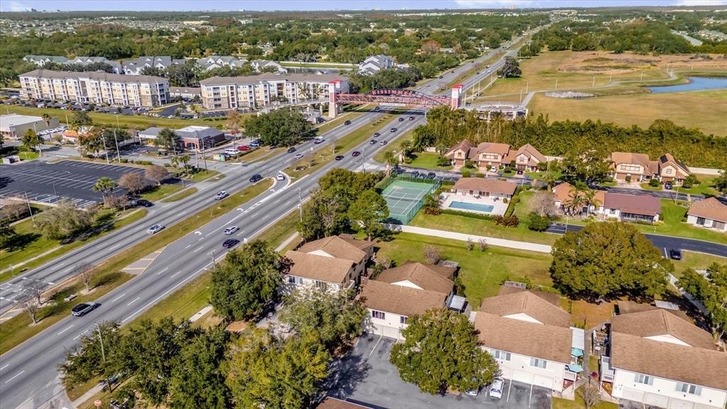 1121 Spring Meadow Drive, Unit 11221 Kissimmee, FL 34741 - Photo 27 of 28 an aerial view of a city with lots of residential buildings ocean and mountain view in back