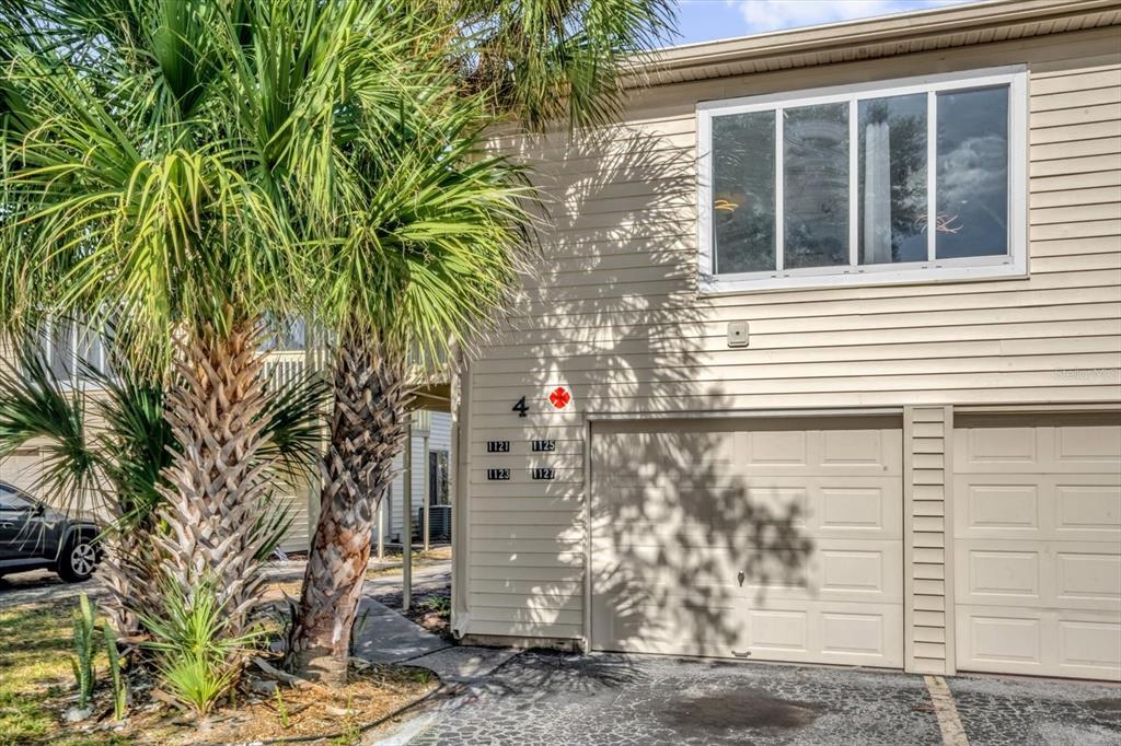 1121 Spring Meadow Drive, Unit 11221 Kissimmee, FL 34741 - Photo 3 of 28 a small white house with a tree in front of it