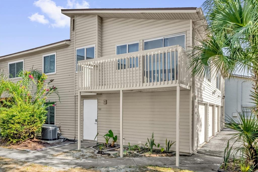 1121 Spring Meadow Drive, Unit 11221 Kissimmee, FL 34741 - Photo 4 of 28 a front view of a house with plants