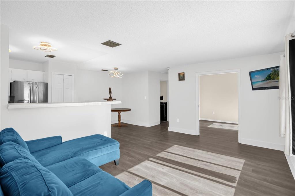 1121 Spring Meadow Drive, Unit 11221 Kissimmee, FL 34741 - Photo 5 of 28 a living room with furniture and a wooden floor