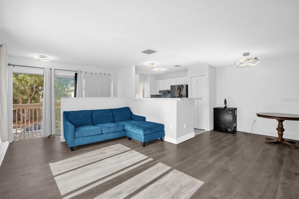 1121 Spring Meadow Drive, Unit 11221 Kissimmee, FL 34741 - Photo 6 of 28 a living room with furniture and a wooden floor